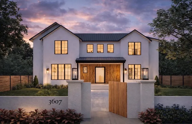 Modern home exterior at dusk with black-framed windows and a wood-slat covered entry