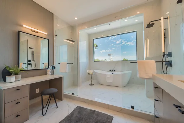 Bedroom with sculptural pendant lighting and a floor-to-ceiling view of the city