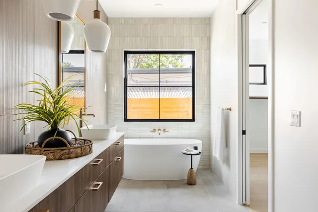 Bathroom with a freestanding tub set beneath a large window